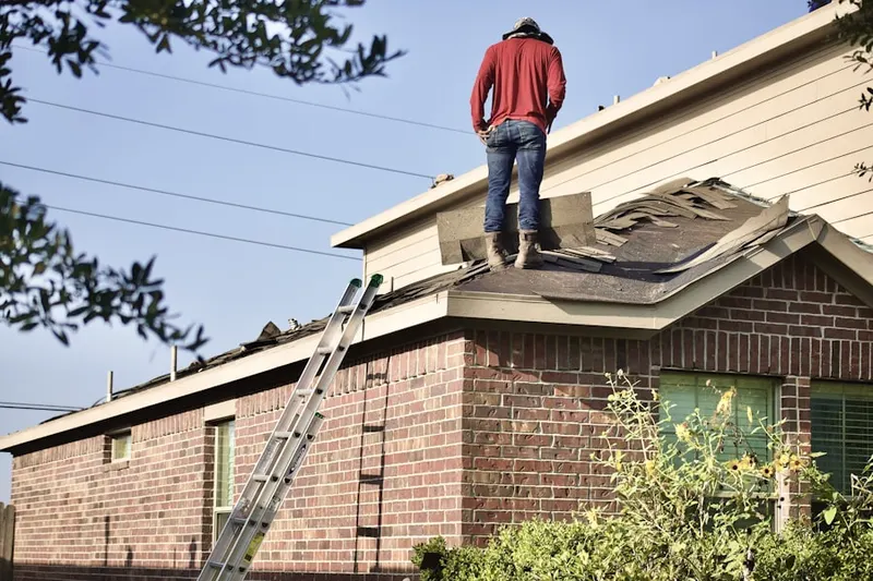 Professional roofer working on a residential roof in Douglass Ridge